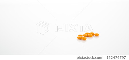 Yellow sugar coated tablet pills on white background for pharmaceutical research, drug discovery and new medicine development in healthcare industry. Pharmacology innovation in healthcare science. 132474797