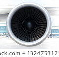 Front view of a jet engine with turbine blades visible 132475312
