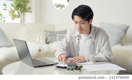 Asian man considering real estate Asian man considering real estate 132476699