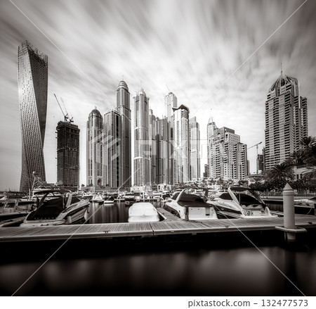 Panoramic view of Dubai Marina bay with yacht and cloudy sky, Dubai, UAE 132477573