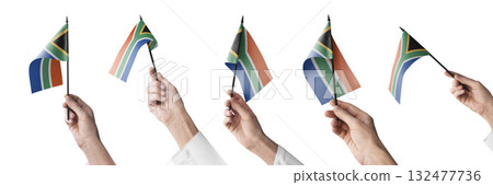 The South Africa flag in hand in different angles on a white background 132477736
