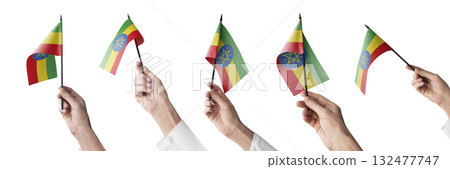 The Ethiopia flag in hand in different angles on a white background 132477747