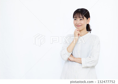 Woman thinking with a smile 132477752