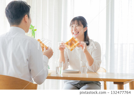 A working couple eating breakfast A working couple eating breakfast 132477764
