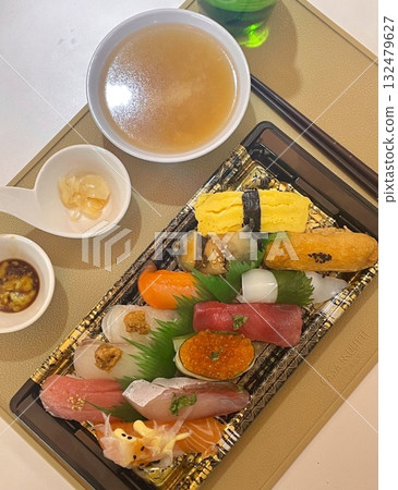 An assortment of fresh sushi, artfully arranged with a variety of toppings and vibrant colors. This traditional Japanese dish combines vinegared rice, seafood, and vegetables for an experience. An assortment of fresh sushi, artfully arranged with a variety of toppings and vibrant colors. This traditional Japanese dish combines vinegared rice, seafood, and vegetables for an experience. 132479627