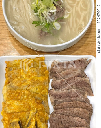 Warm and comforting kalguksu with hand-cut noodles in rich, savory broth, served with vegetables and sometimes seafood or chicken—offering a perfect bowl of hearty flavor and soothing texture in every 132479642