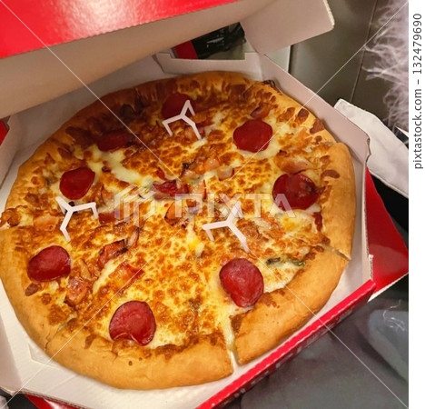 A delicious pizza with a golden crust, melted cheese, and savory toppings. Perfect for food-related designs, menus, or Italian-themed projects, capturing the essence of a classic comfort dish. 132479690