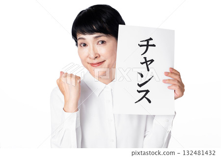 一位老年婦女微笑著握拳，手裡拿著一張寫著「機會」的紙 132481432
