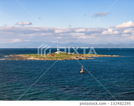 Omazaki, Benten Island, Omazaki Lighthouse, and a view of Hokkaido across the shore. Oma Town, Aomori Prefecture (aerial photo taken by drone) Omazaki, Benten Island, Omazaki Lighthouse, and a view of Hokkaido across the shore. Oma Town, Aomori Prefecture (aerial photo taken by drone) 132482295