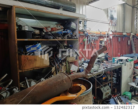 A mess in the workshop, an unorganized garage. A mess in the workshop, an unorganized garage. 132482317