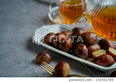 Chestnuts simmered in their skins | A refined dessert with the aroma of syrup Chestnuts simmered in their skins | A refined dessert with the aroma of syrup 132482789