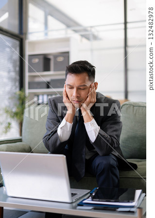 stressed Asian businessman working in the office. Businessman thinking too much work concept in the office. 132482978