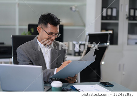 Businessmanare calculating income-expenditure and analyzing real estate investment data at office, Accounting Financial and tax systems concept. Businessmanare calculating income-expenditure and analyzing real estate investment data at office, Accounting Financial and tax systems concept. 132482983