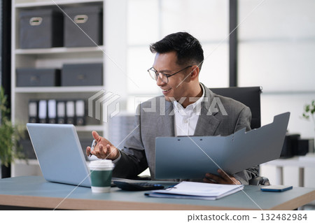 Male businessman using a tablet and computer to analysis graph company financial in office. 132482984