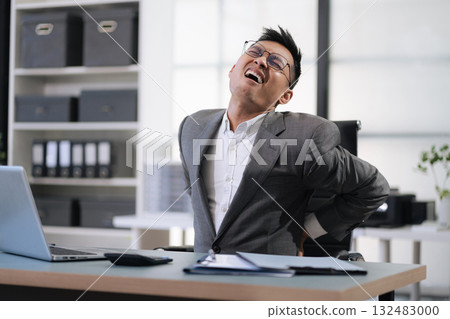 Male businessman is doing a stretchy posture due to sitting in the office for too long, office syndrome concept. Male businessman is doing a stretchy posture due to sitting in the office for too long, office syndrome concept. 132483000