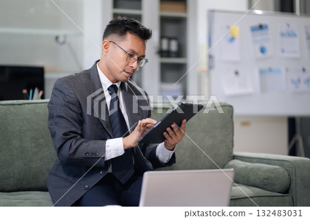 Businessman using laptop computer in office. Happy man, entrepreneur, small business owner working online. 132483031