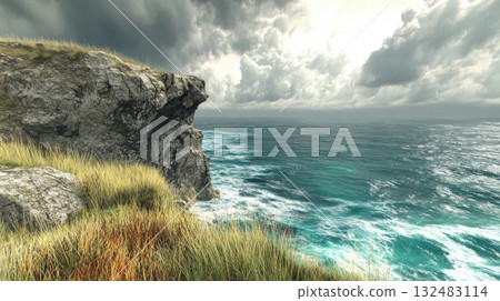 Coastal cliff with grassy edge and rugged stone formations overlooking turquoise waves and an overcast sky 132483114