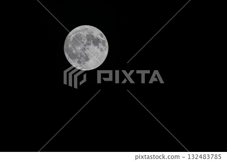 Full moon floating in the night sky 132483785