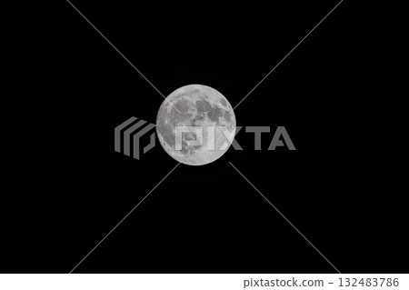 Full moon floating in the night sky 132483786