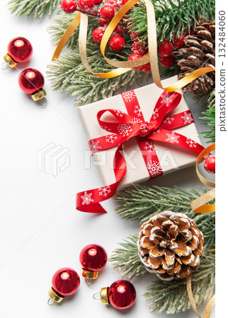 Christmas giftbox with pine branches and ornaments 132484060