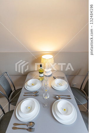 Minimalist Table Setting with Lamp and White Dishes Minimalist Table Setting with Lamp and White Dishes 132484196
