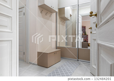 Cozy Hallway with Mirror Wardrobe and Light Beige Interior Cozy Hallway with Mirror Wardrobe and Light Beige Interior 132484201