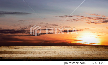 Rustic wooden table surface with sunset scene background. Mockup, template, or copy space. Product display and promotional content Rustic wooden table surface with sunset scene background. Mockup, template, or copy space. Product display and promotional content 132484355