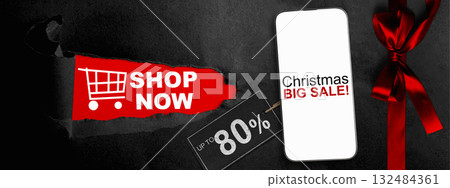 Christmas big sale text on cellphone screen with red ribbon and up to 80% text on the label tag. Copy space. Christmas sale concept 132484361