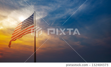Closeup view of the American flag waving with dramatic sky background. Copy space. American holiday backdrop Closeup view of the American flag waving with dramatic sky background. Copy space. American holiday backdrop 132484373