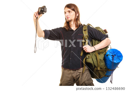 Man tourist backpacker taking photo with camera. Man tourist backpacker taking photo with camera. 132486690