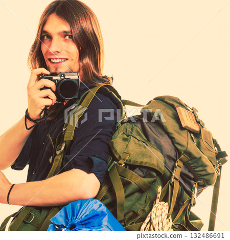Man tourist backpacker taking photo with camera. 132486691