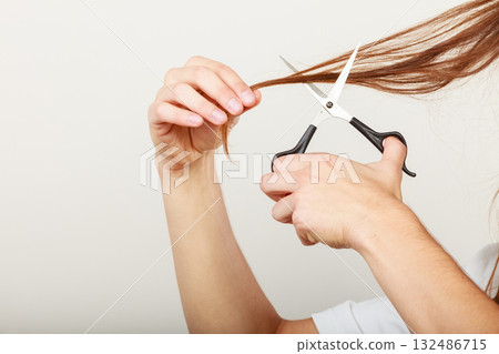 Male hands cutting long hair Male hands cutting long hair 132486715