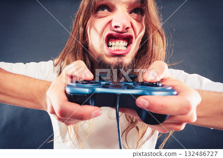 Stressed man playing on pad Stressed man playing on pad 132486727