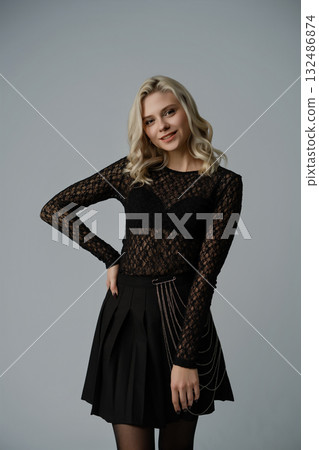 Elegant young woman poses in stylish outfit showcasing modern fashion and confidence 132486874