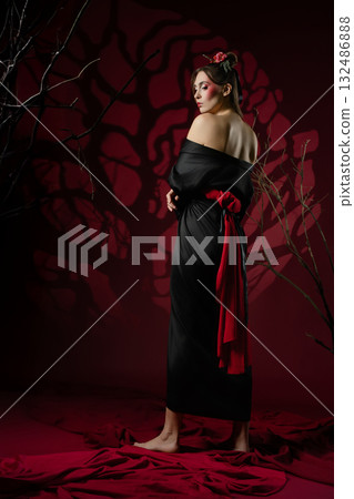 Elegance in traditional Japanese dress captured in a studio setting with dark accents 132486888