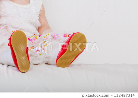 Little girl with red shoes Little girl with red shoes 132487314