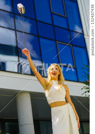 Cheerful fashionable woman in city Cheerful fashionable woman in city 132487436