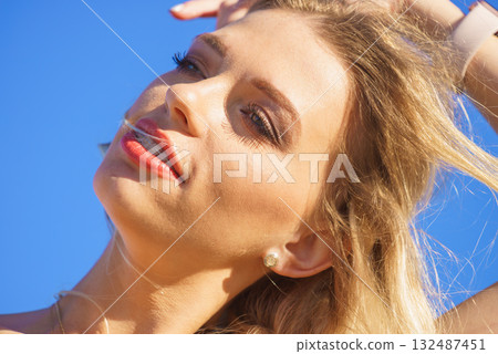 Face of young woman in sunlight Face of young woman in sunlight 132487451