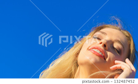 Face of young woman in sunlight 132487452