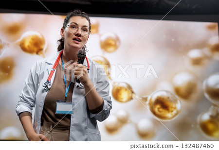 woman is giving a presentation at a conference woman is giving a presentation at a conference 132487460