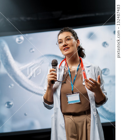 woman is giving a presentation at a conference woman is giving a presentation at a conference 132487483