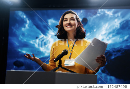 woman is giving a presentation at conference 132487496