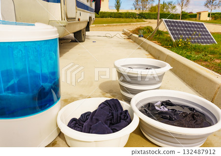 Washing laundry outdoor at caravan 132487912