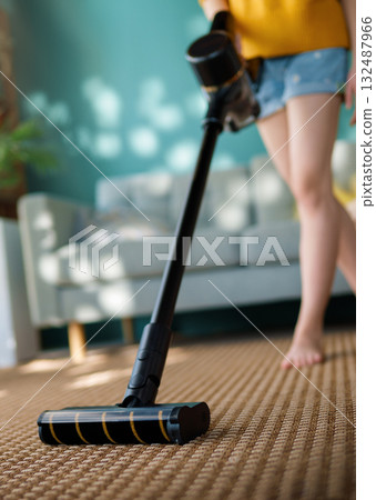 woman vacuuming floor woman vacuuming floor 132487966