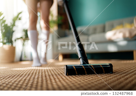 woman vacuuming floor 132487968