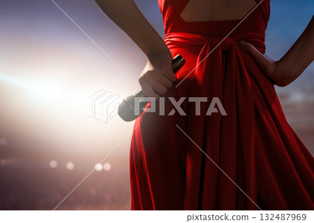 A singer on stage with a microphone A singer on stage with a microphone 132487969