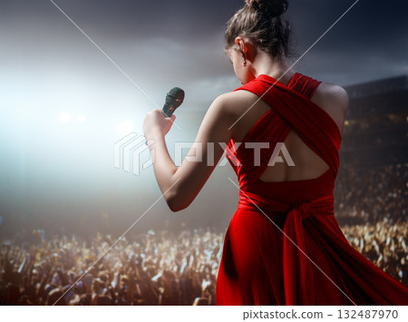 A singer on stage with a microphone 132487970