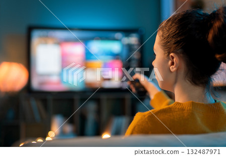 woman watching TV at home woman watching TV at home 132487971