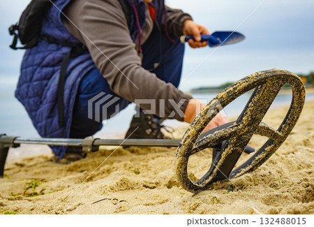 Man with metal detector on sea beach Man with metal detector on sea beach 132488015