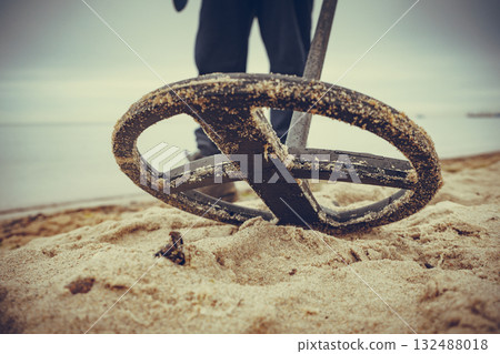 Man with metal detector on sea beach Man with metal detector on sea beach 132488018